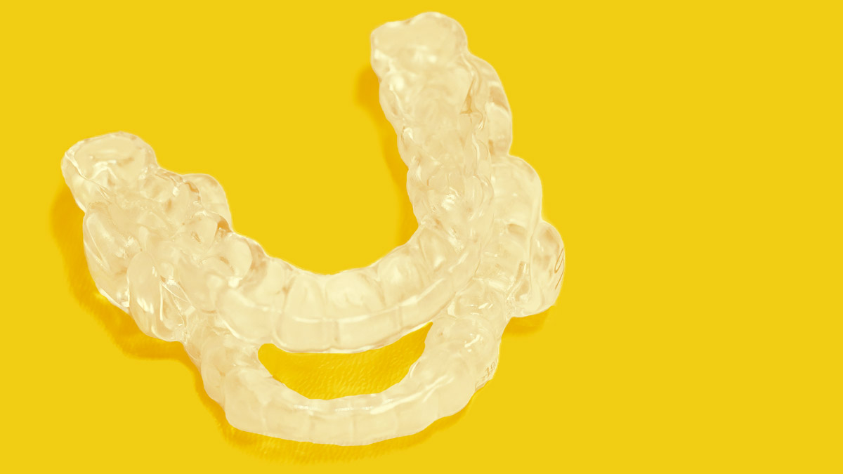 ADVENT ProSomnus Transparent Oral Appliance on a Yellow Background - 1200x675