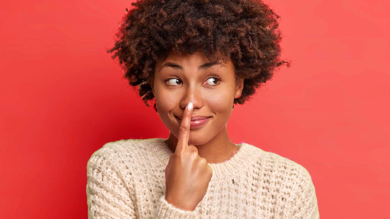 Dark Skinned Young Women Pointing at Her Nose - 1280x720